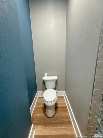 a white toilet sitting in a bathroom