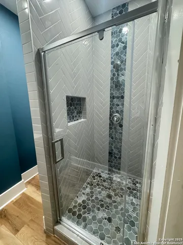 a bathroom with a shower and a sink