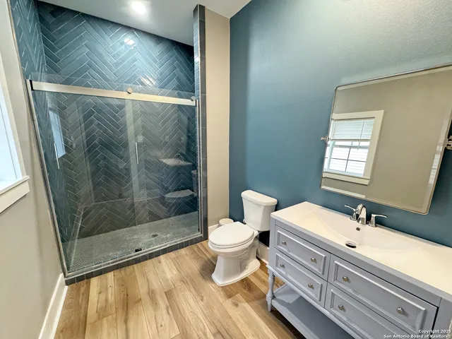a bathroom with a double vanity sink toilet and shower