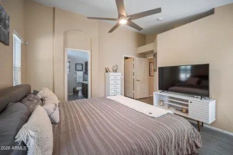 a bedroom with a bed and a flat screen tv