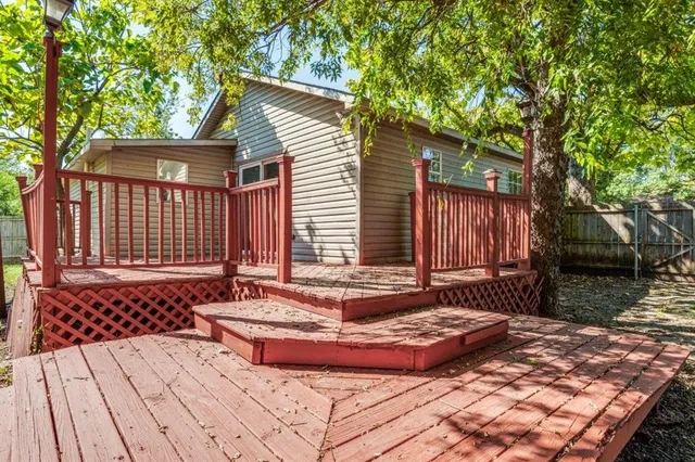 a view of a backyard with a large tree
