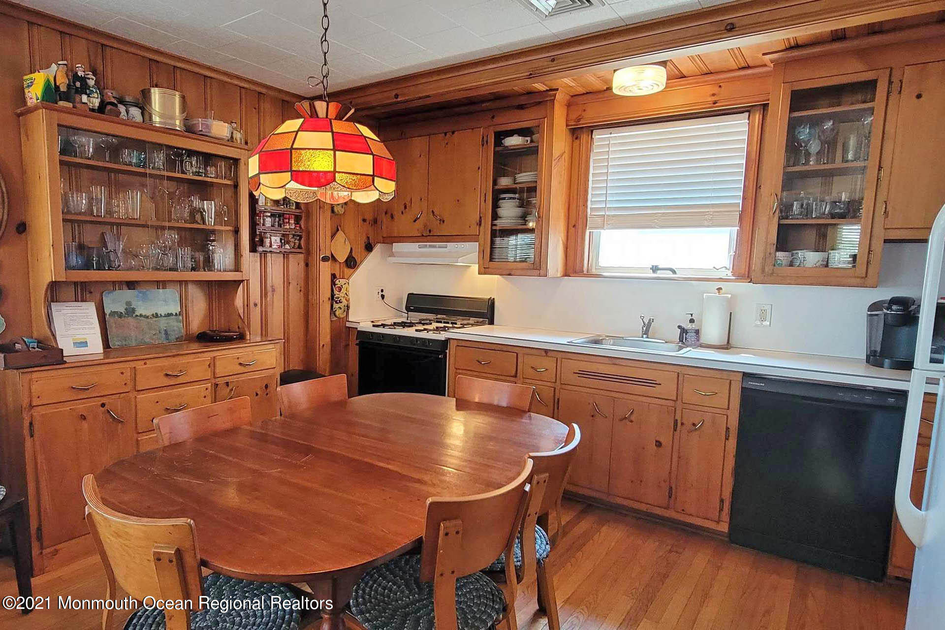 1 Brooklyn Avenue Lavallette, NJ 08735 - Photo 11 of 55 a kitchen with stainless steel appliances granite countertop a stove a sink dishwasher a dining table and chairs with wooden floor