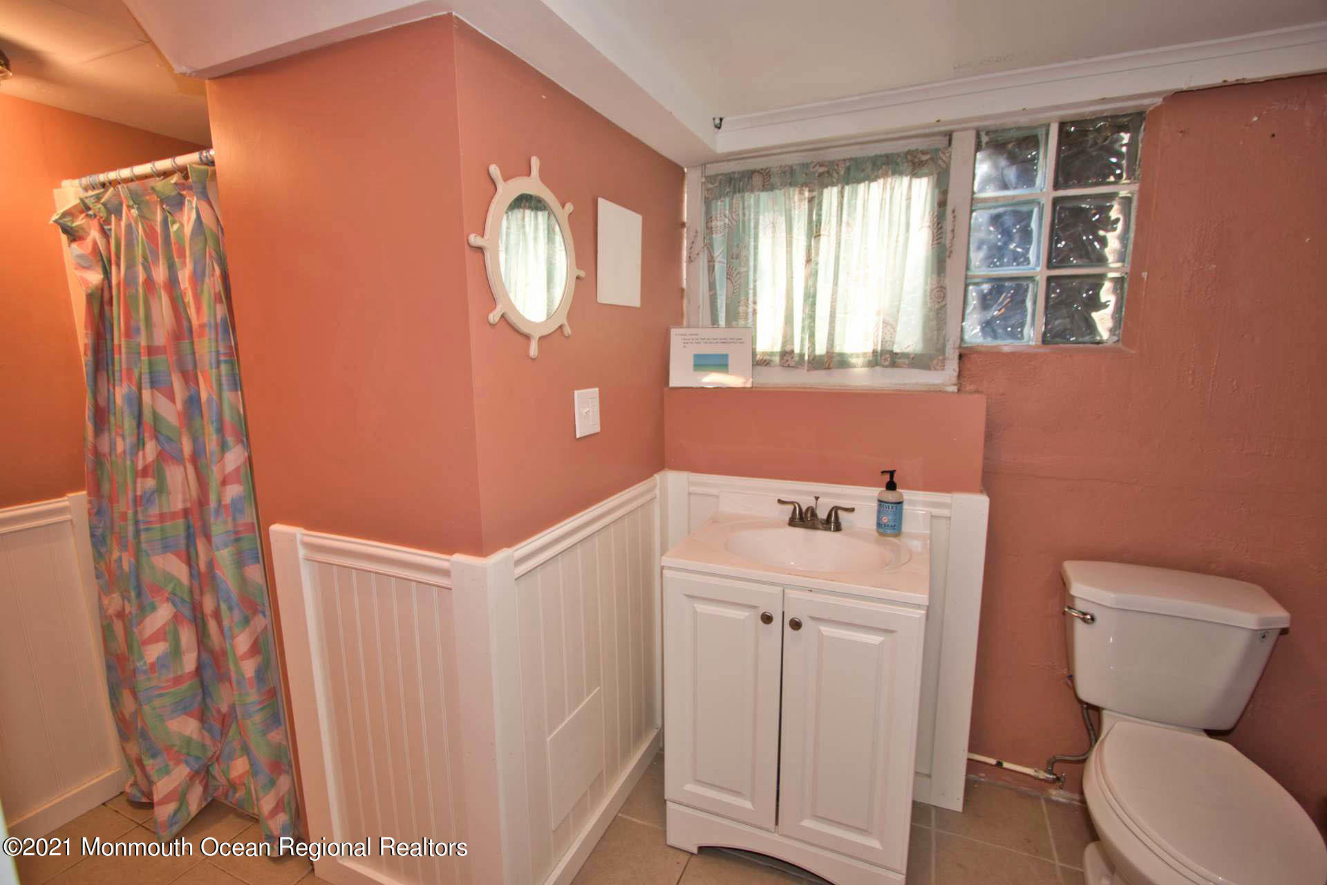 1 Brooklyn Avenue Lavallette, NJ 08735 - Photo 23 of 55 a bathroom with a sink a toilet and a window