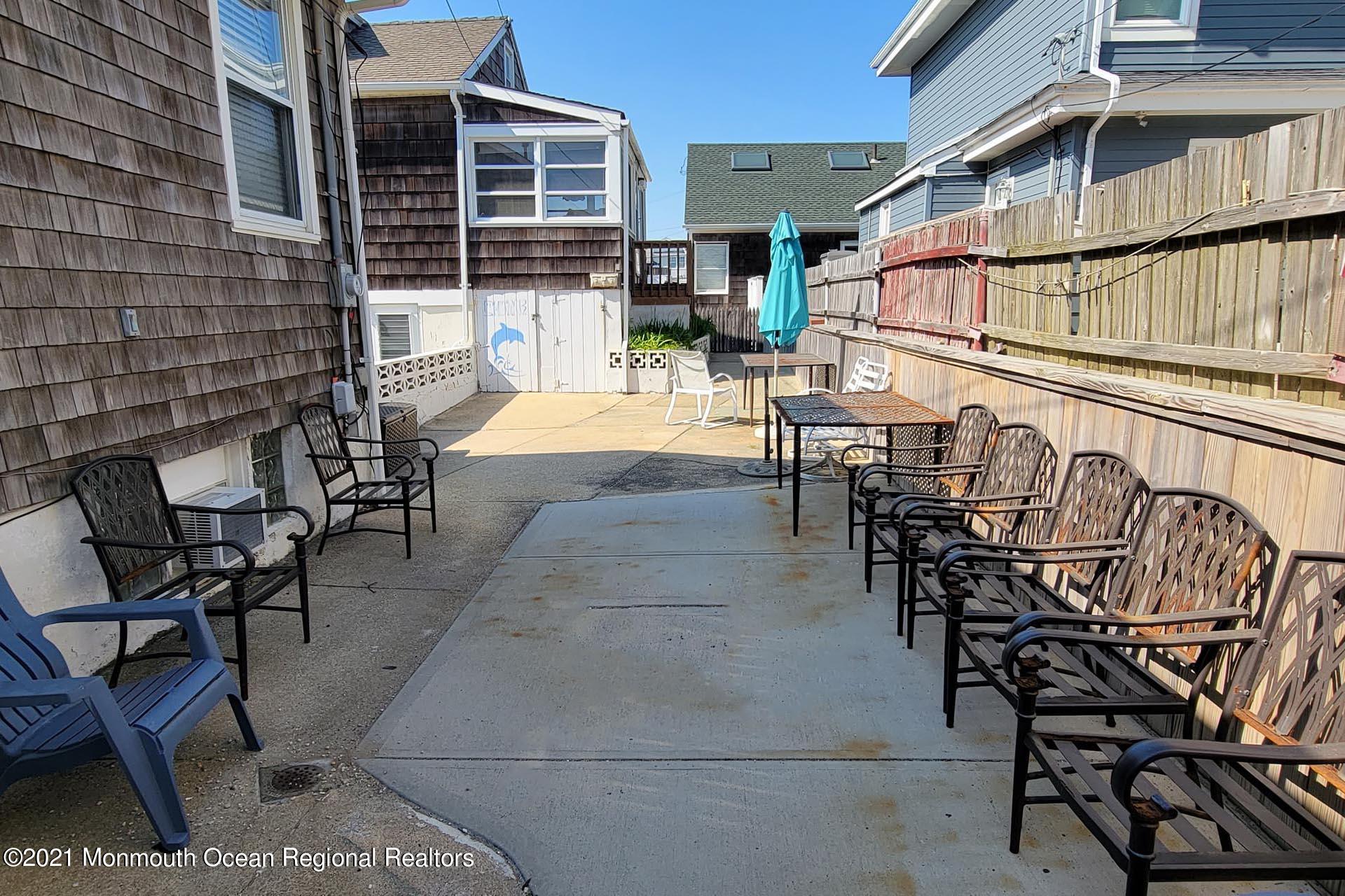 1 Brooklyn Avenue Lavallette, NJ 08735 - Photo 25 of 55 a view of a patio with table and chairs with wooden floor and fence