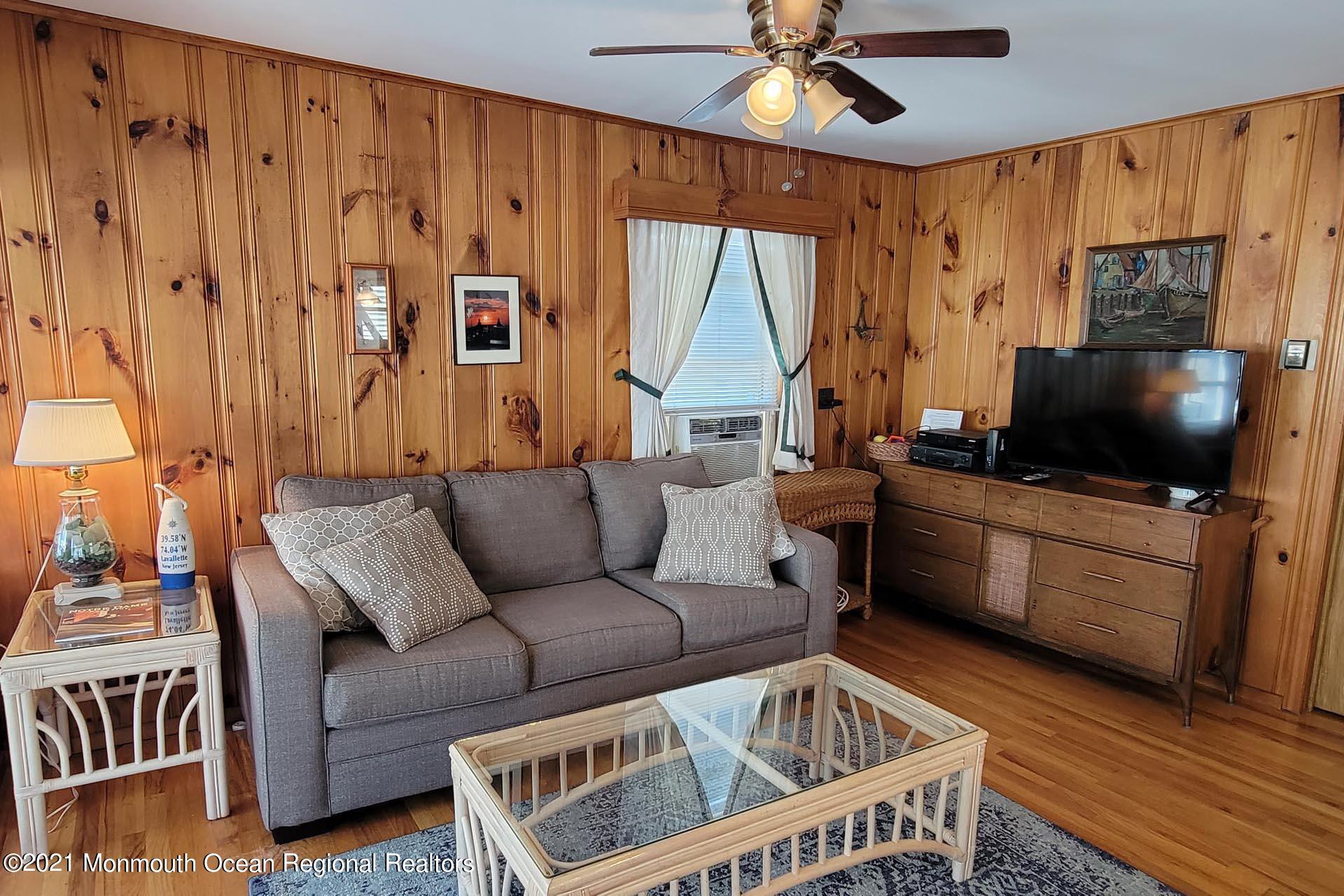 1 Brooklyn Avenue Lavallette, NJ 08735 - Photo 28 of 55 a living room with furniture and a flat screen tv