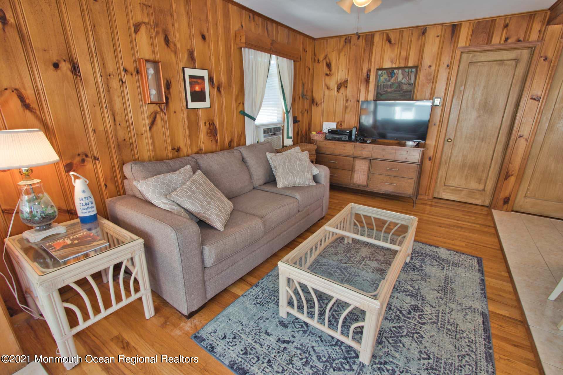 1 Brooklyn Avenue Lavallette, NJ 08735 - Photo 30 of 55 a living room with furniture and a flat screen tv