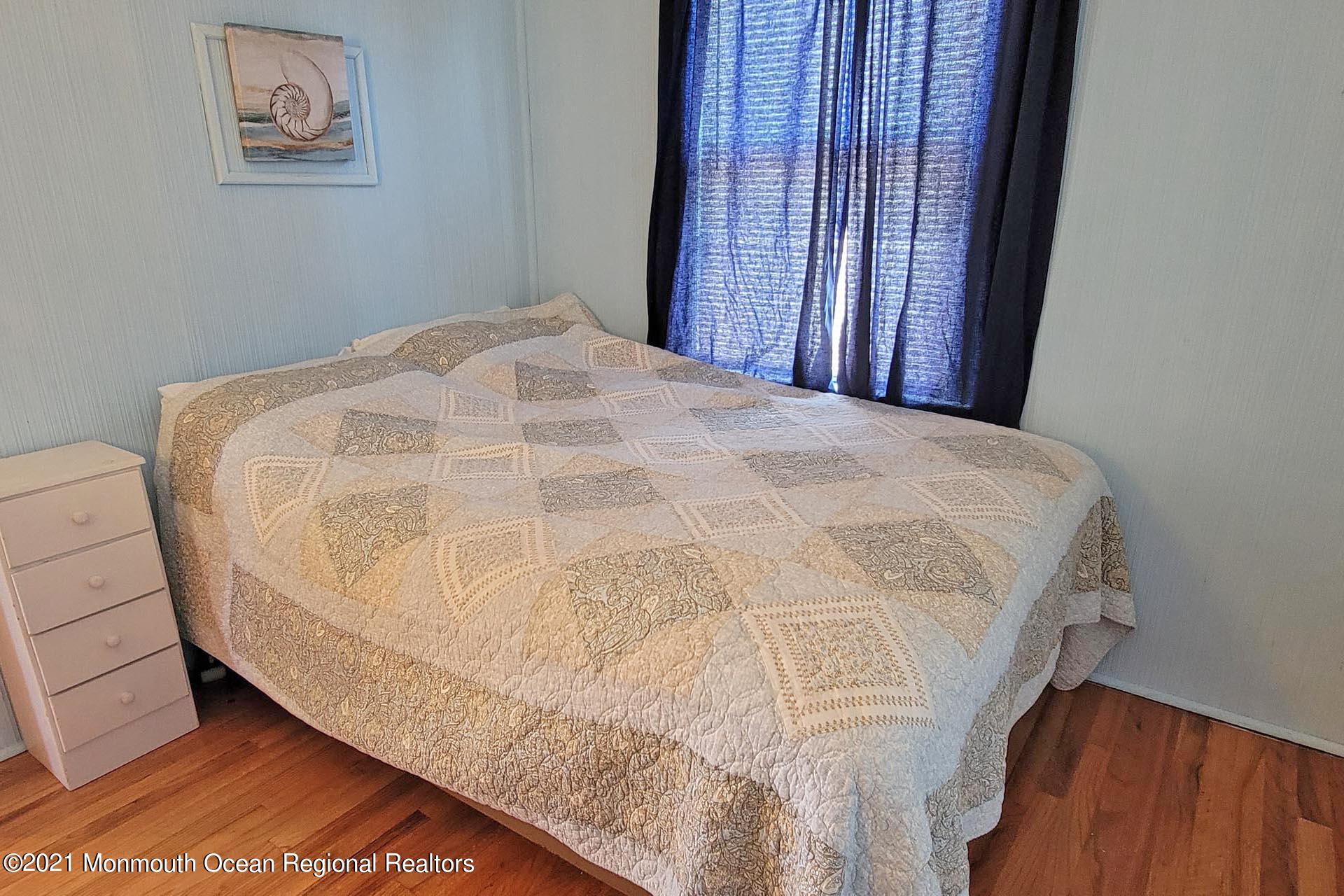 1 Brooklyn Avenue Lavallette, NJ 08735 - Photo 34 of 55 a bed sitting in a spacious bedroom next to a window