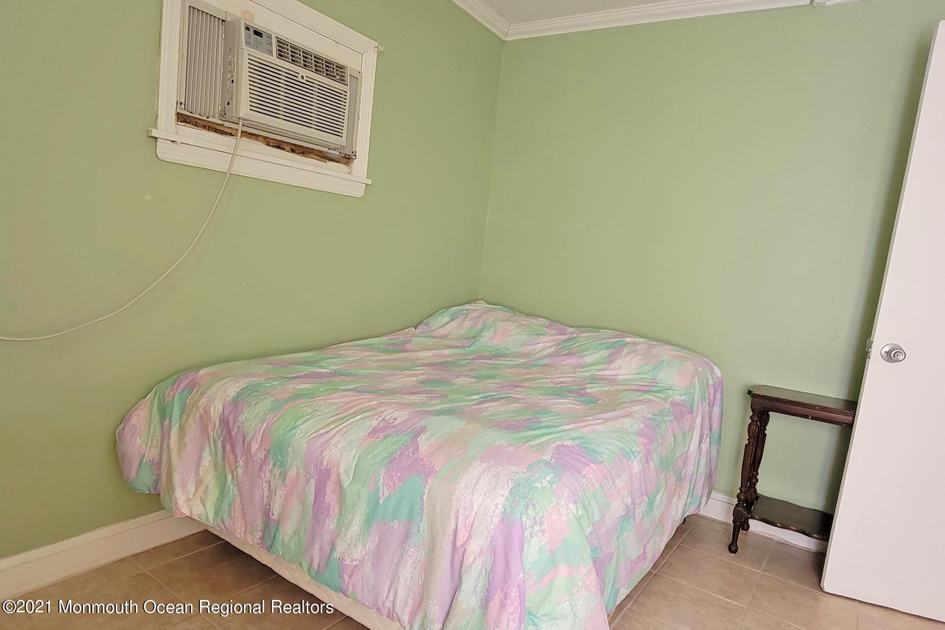 1 Brooklyn Avenue Lavallette, NJ 08735 - Photo 42 of 55 a bedroom with a bed and painting on the wall