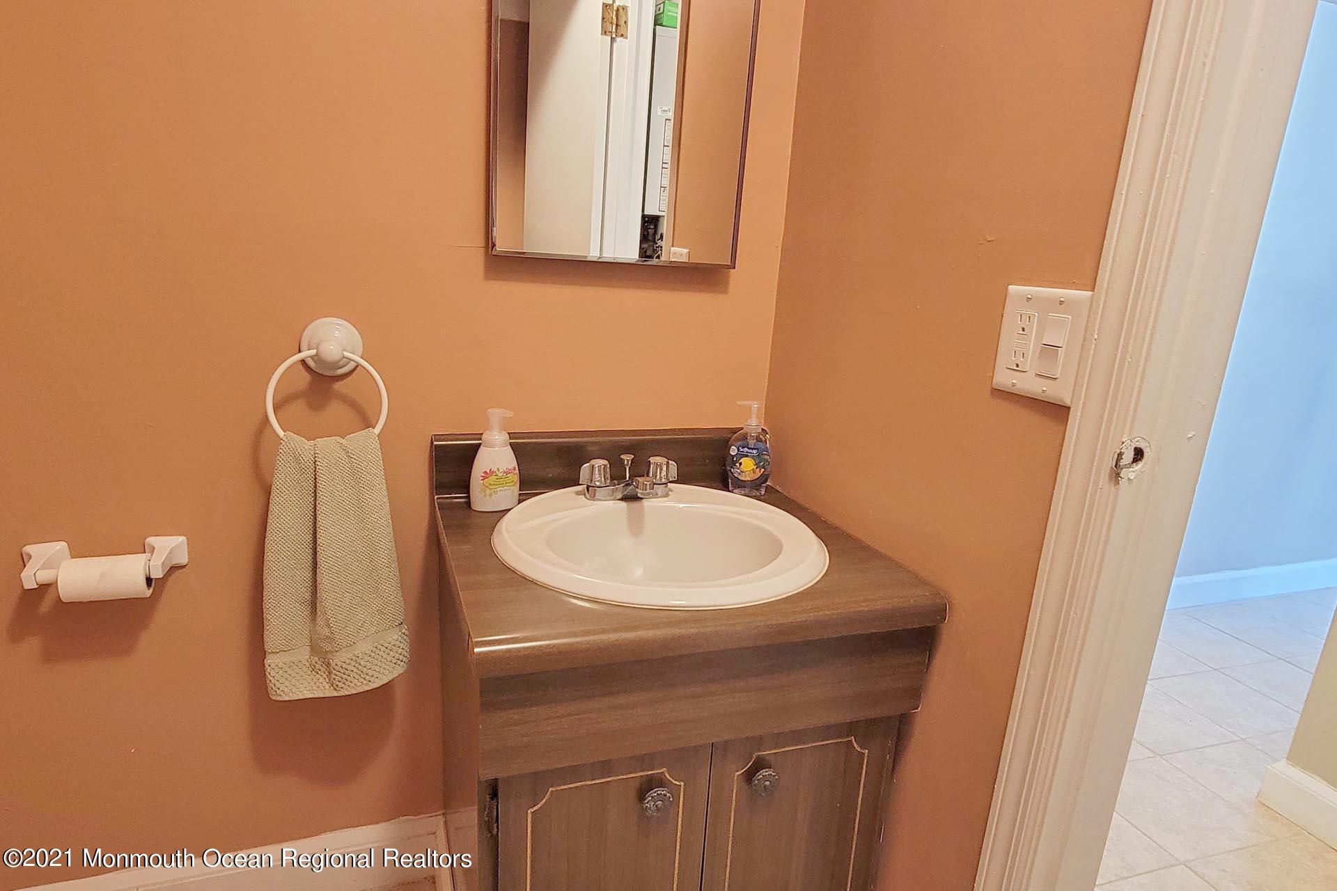 1 Brooklyn Avenue Lavallette, NJ 08735 - Photo 43 of 55 a bathroom with a sink and a mirror