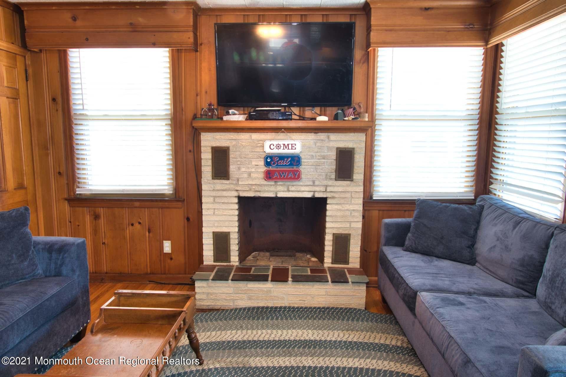 1 Brooklyn Avenue Lavallette, NJ 08735 - Photo 9 of 55 a living room with furniture a flat screen tv and a window