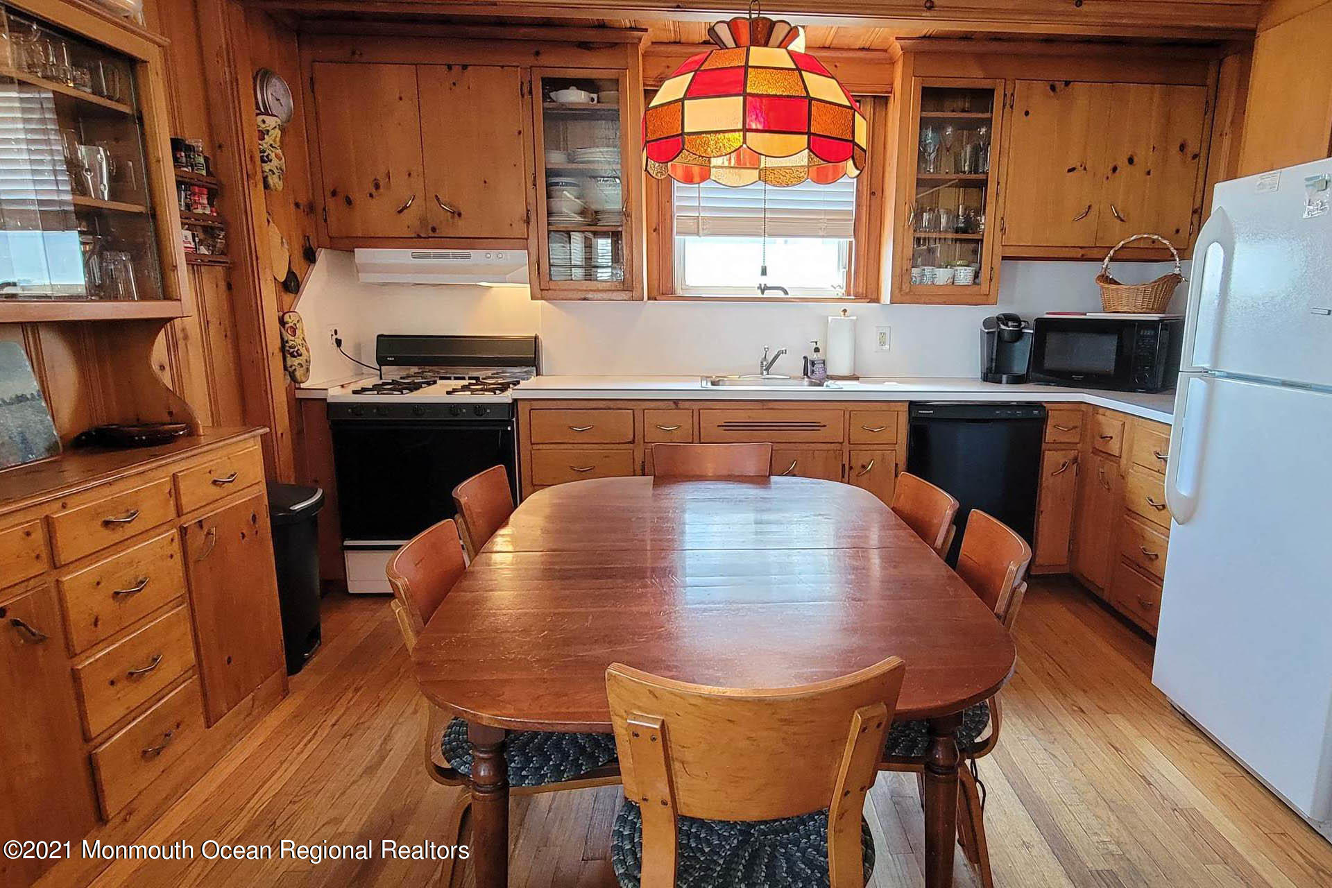 1 Brooklyn Avenue Lavallette, NJ 08735 - Photo 10 of 55 a kitchen with stainless steel appliances granite countertop a sink a stove a refrigerator a dining table and chairs with wooden floor
