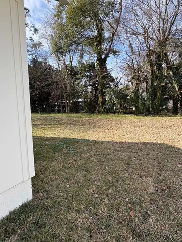 a kitchen with stainless steel appliances a stove a sink a refrigerator a center island and a window