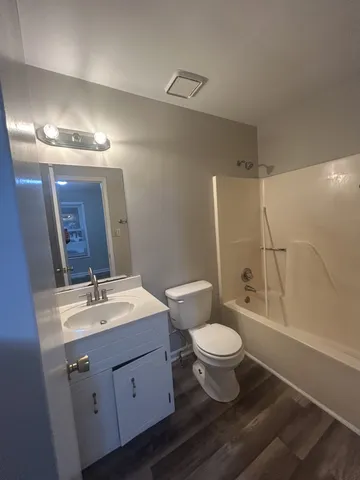 a bathroom with a double vanity sink toilet and a mirror