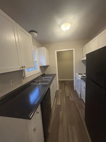 a kitchen with a sink appliances and cabinets