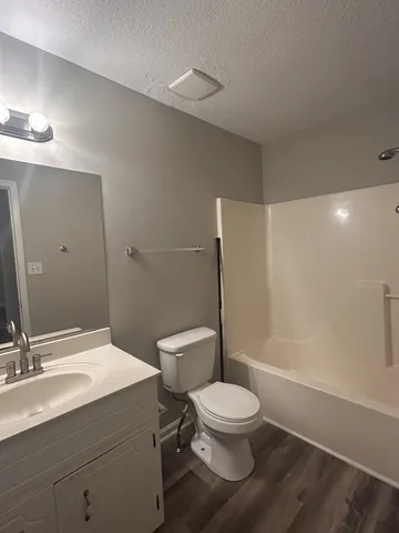 a bathroom with a toilet sink and a mirror