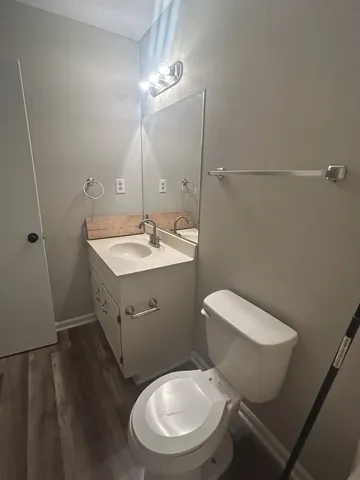 a bathroom with a toilet sink and mirror