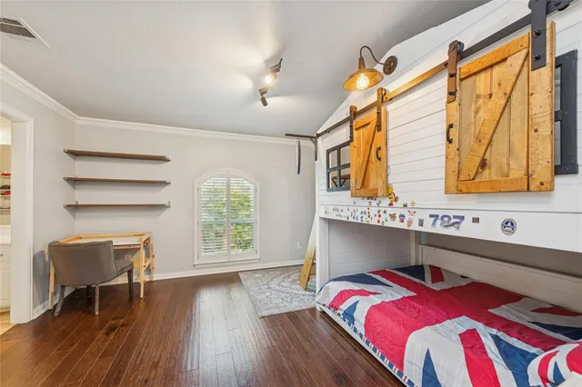 a bedroom with furniture and a wooden floor