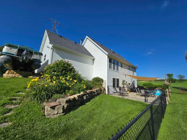 a view of a house with a yard and sitting area