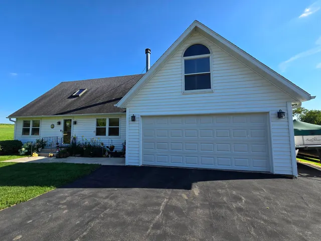a view of a house with a backyard
