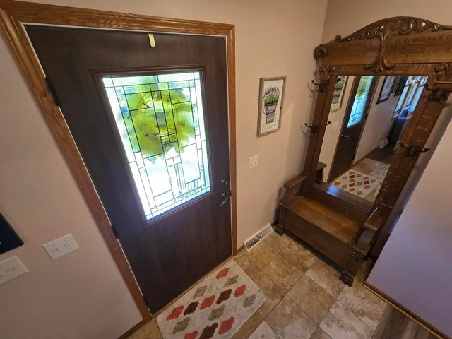 a view of a dining room with furniture a rug and wooden floor