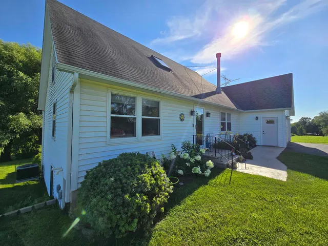 a front view of house with yard and outdoor seating