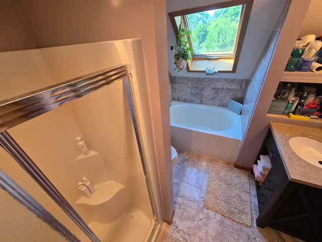 a white toilet sitting next to a bathtub