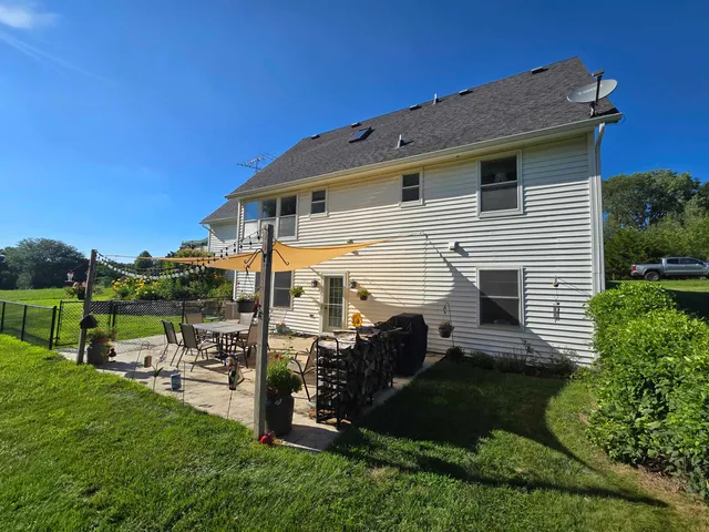a view of a patio with table and chairs with wooden floor and fence