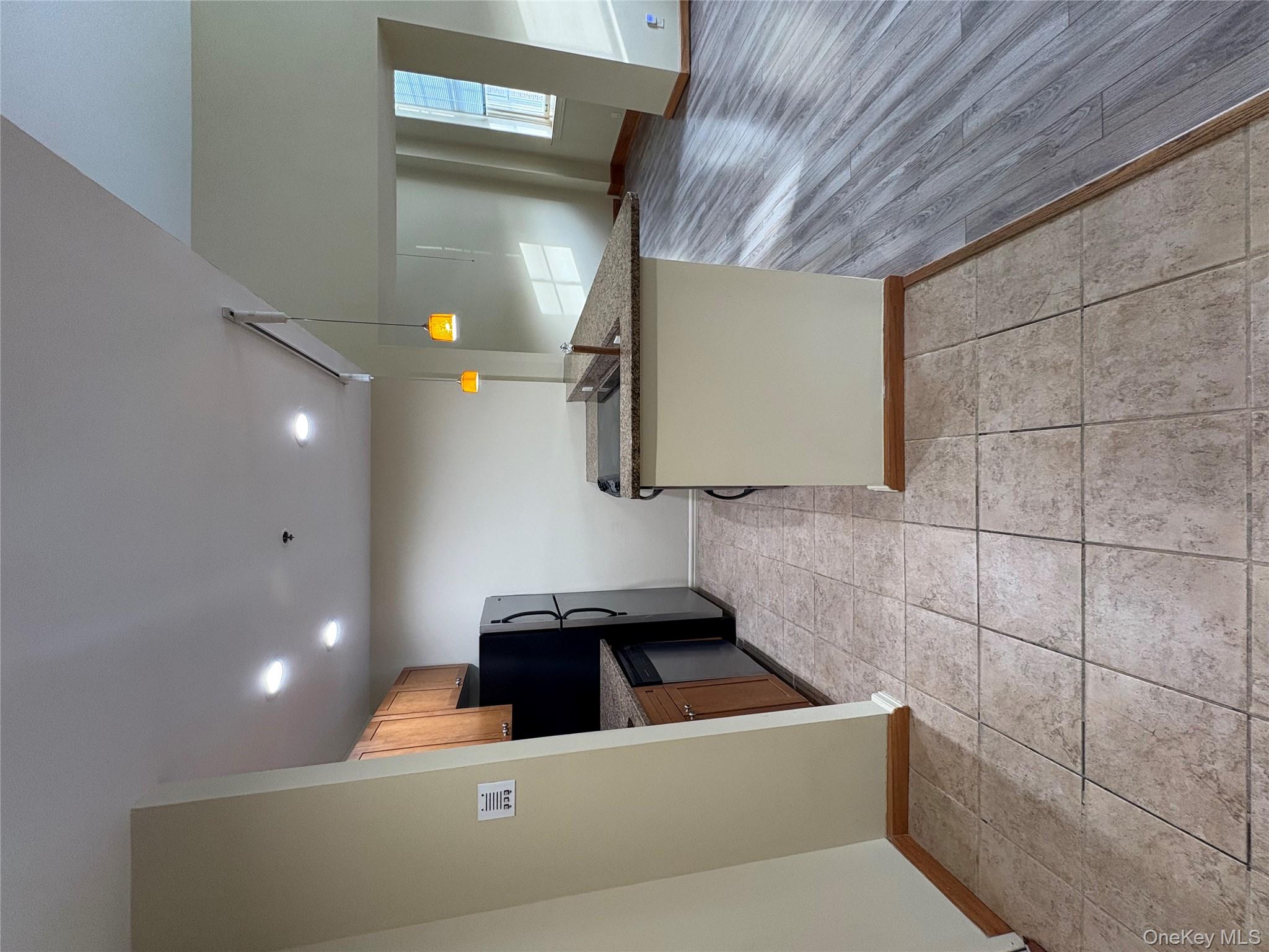 1701 Crompond Road Peekskill, NY 10566 - Photo 15 of 15 a kitchen with stainless steel appliances granite countertop a stove a sink and a microwave