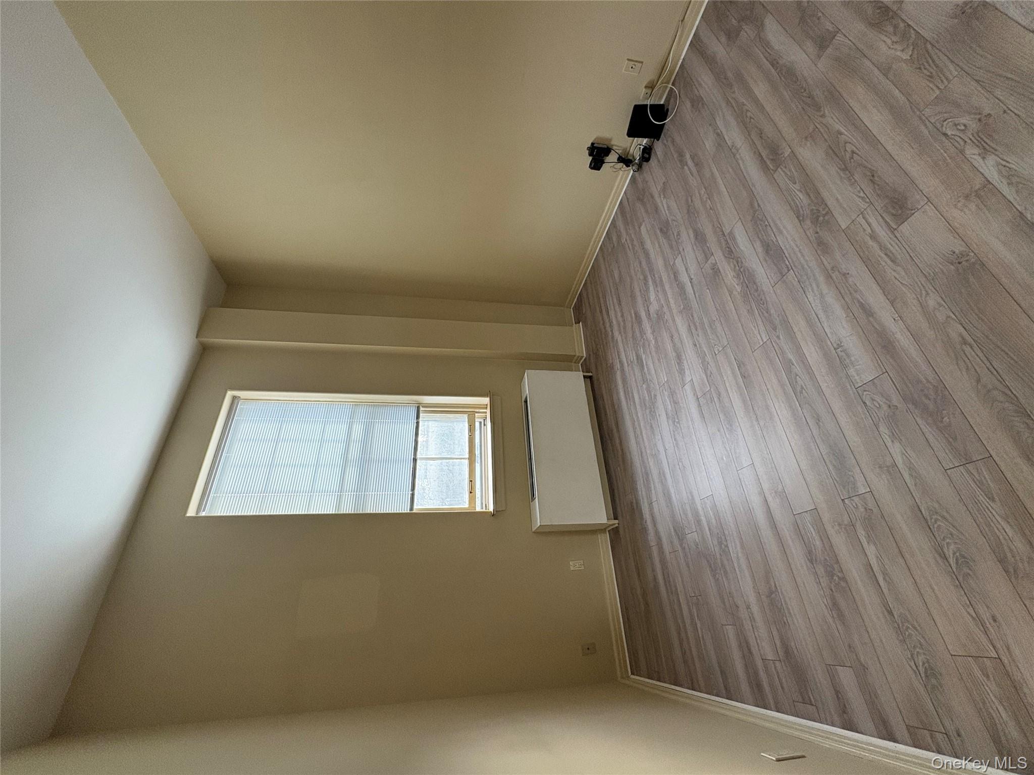 1701 Crompond Road Peekskill, NY 10566 - Photo 6 of 15 an empty room with wooden floor and windows