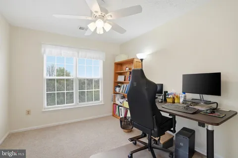 a view of a workspace with bookshelf