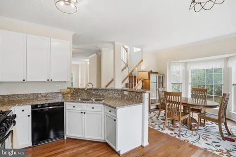 a view of a kitchen counter space and wooden floor