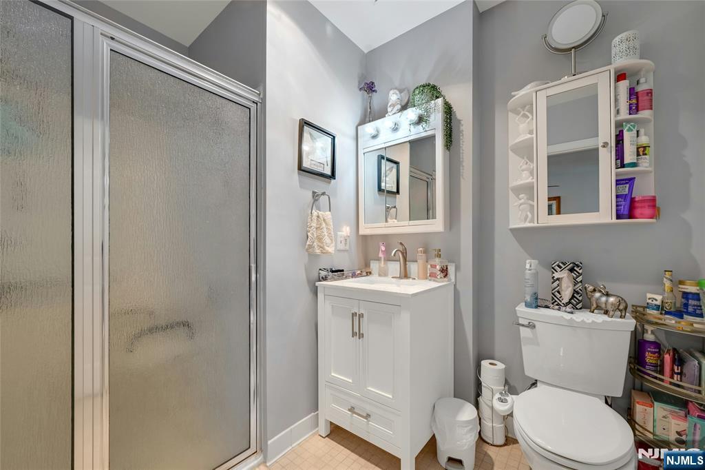 189 Forest Avenue, Unit 117 Paramus, NJ 07652 - Photo 11 of 15 a white toilet sitting next to a bathroom sink