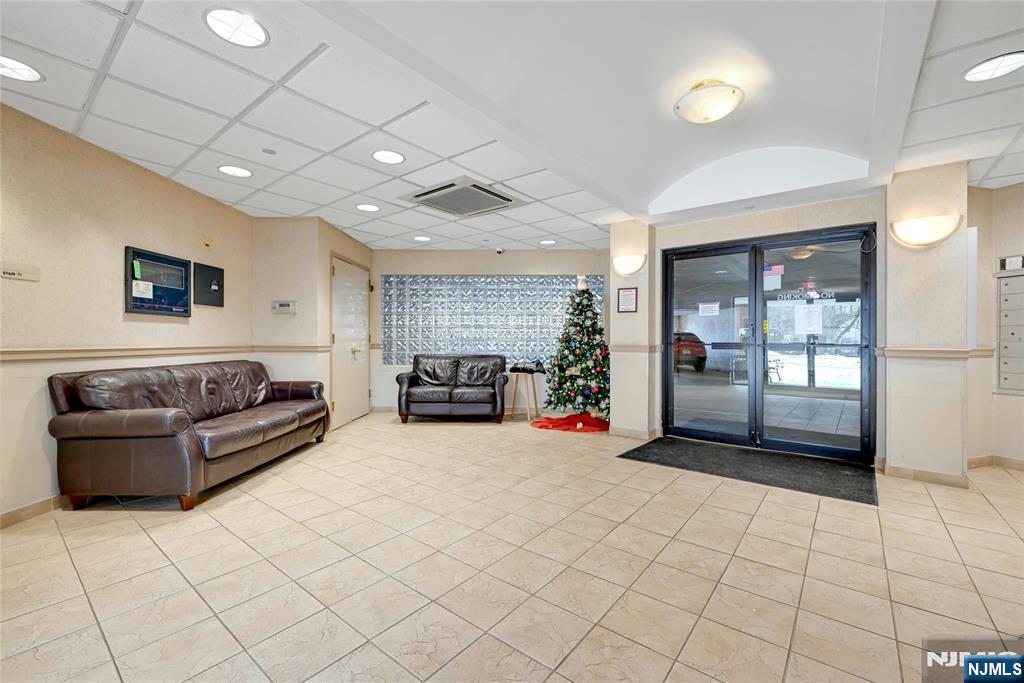 189 Forest Avenue, Unit 117 Paramus, NJ 07652 - Photo 15 of 15 a living room with furniture and a flat screen tv