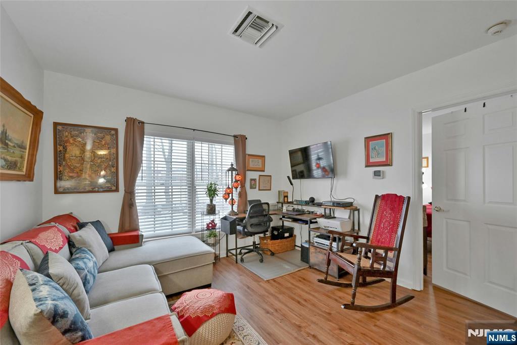 189 Forest Avenue, Unit 117 Paramus, NJ 07652 - Photo 5 of 15 a living room with furniture and a large window