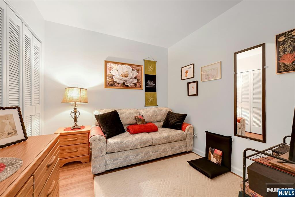 189 Forest Avenue, Unit 117 Paramus, NJ 07652 - Photo 8 of 15 a living room with furniture and a window