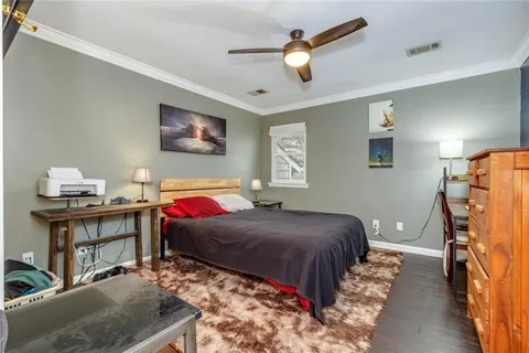 a bedroom with bed and a chandelier