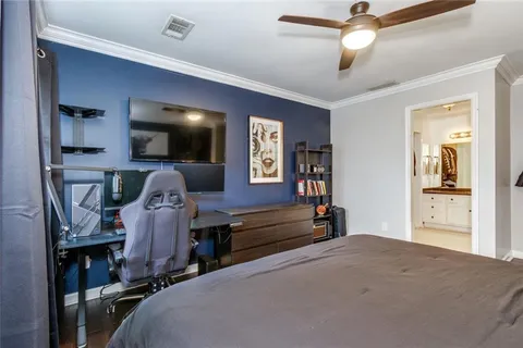 a bedroom with bed and a chandelier