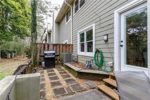 a view of a patio with table and chairs with wooden floor and fence