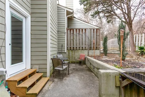 a balcony with furniture and a potted plant