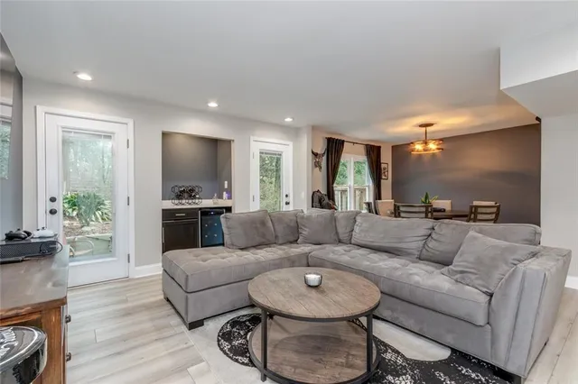 a living room with furniture and a wooden floor