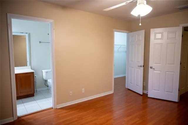 a view of bathroom with a toilet a sink and a mirror