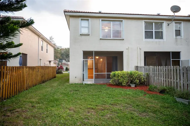 a view of an house with backyard and garden