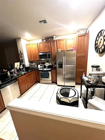 a kitchen with a sink appliances and cabinets