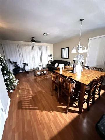 a view of a dining room with furniture and chandelier