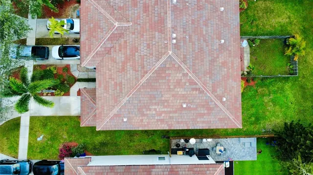 an aerial view of a house with a yard and garden