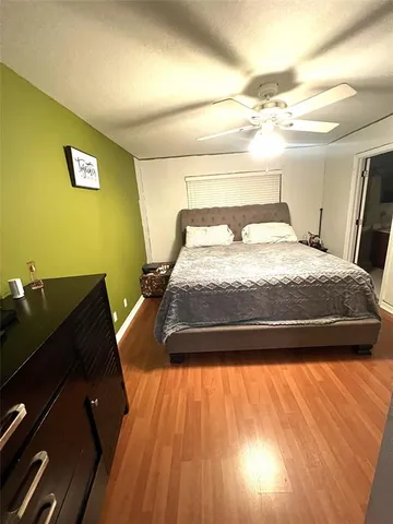 a bed sitting in a bedroom next to a larger window