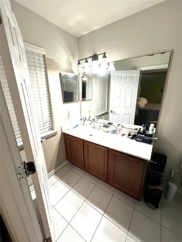 a bathroom with a sink a mirror and a bathtub