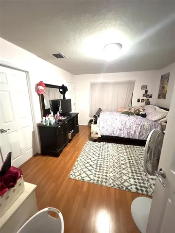 a bedroom with furniture and a flat screen tv