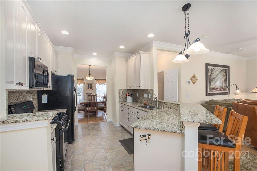 163 Snead Road Fort Mill, SC 29715 - Photo 8 of 33 a kitchen with stainless steel appliances granite countertop a sink stove and refrigerator