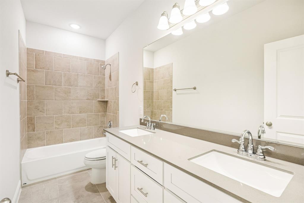 817 Heart Reef Road Plano, TX 75075 - Photo 19 of 21 a bathroom with a granite countertop sink a toilet and bathtub